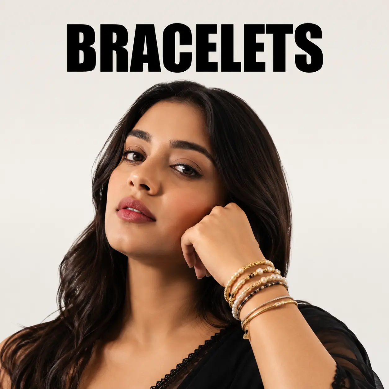 Women's gold bracelet collection on an Indian fashion model featuring stacked bangles and elegant wrist accessories.